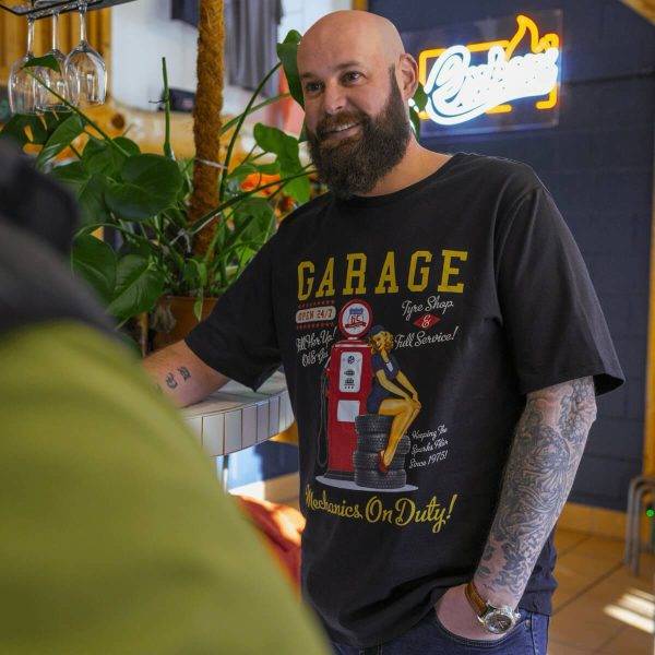 Model wearing the Lébrett The Garage T-Shirt in Black.