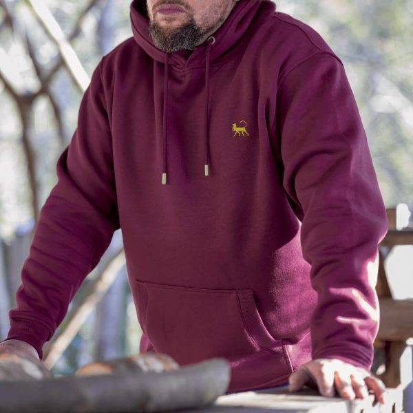 Outdoors image of a model wearing Lébrett's Grove Hoodie in Plum.