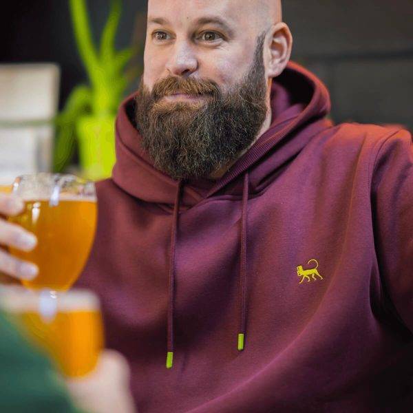 Model having a beer while wearing Lébrett's Grove Hoodie in Plum. Premium casual wear for plus size men.